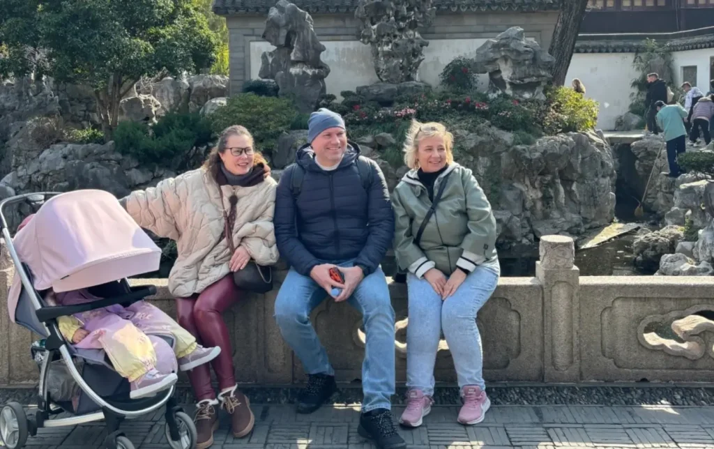 family tourists relaxing at yuyuan garden in shanghai enjoying a cultural sightseeing experience