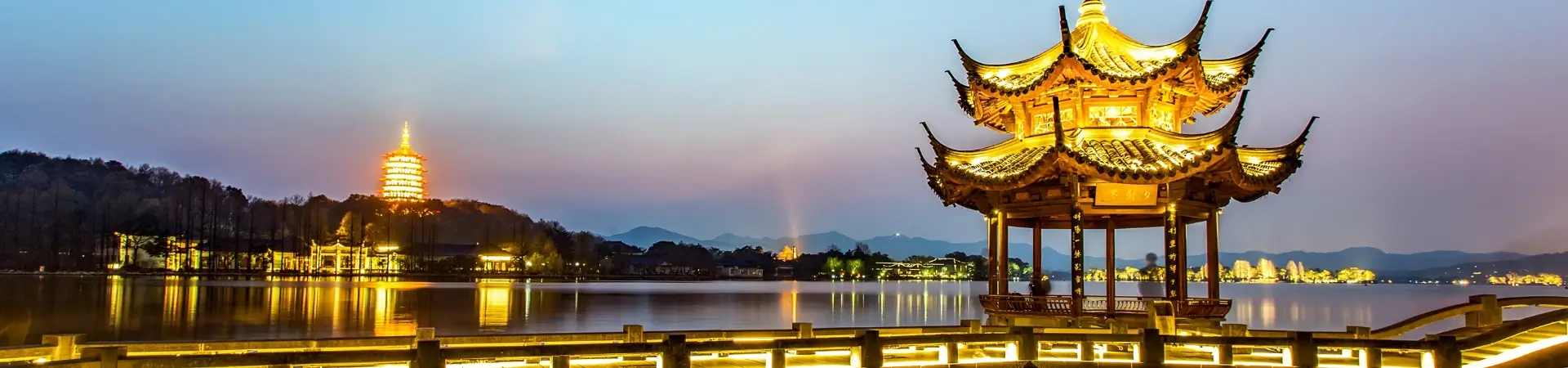 West Lake in Hangzhou at night with Leifeng Pagoda and traditional pavilion illuminated