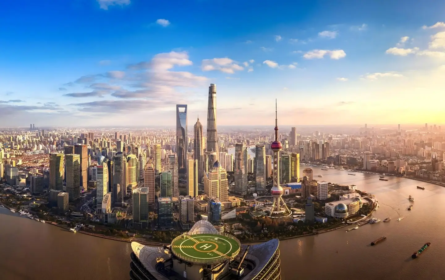 Aerial view of Shanghai skyline and Huangpu River at sunset with futuristic skyscrapers