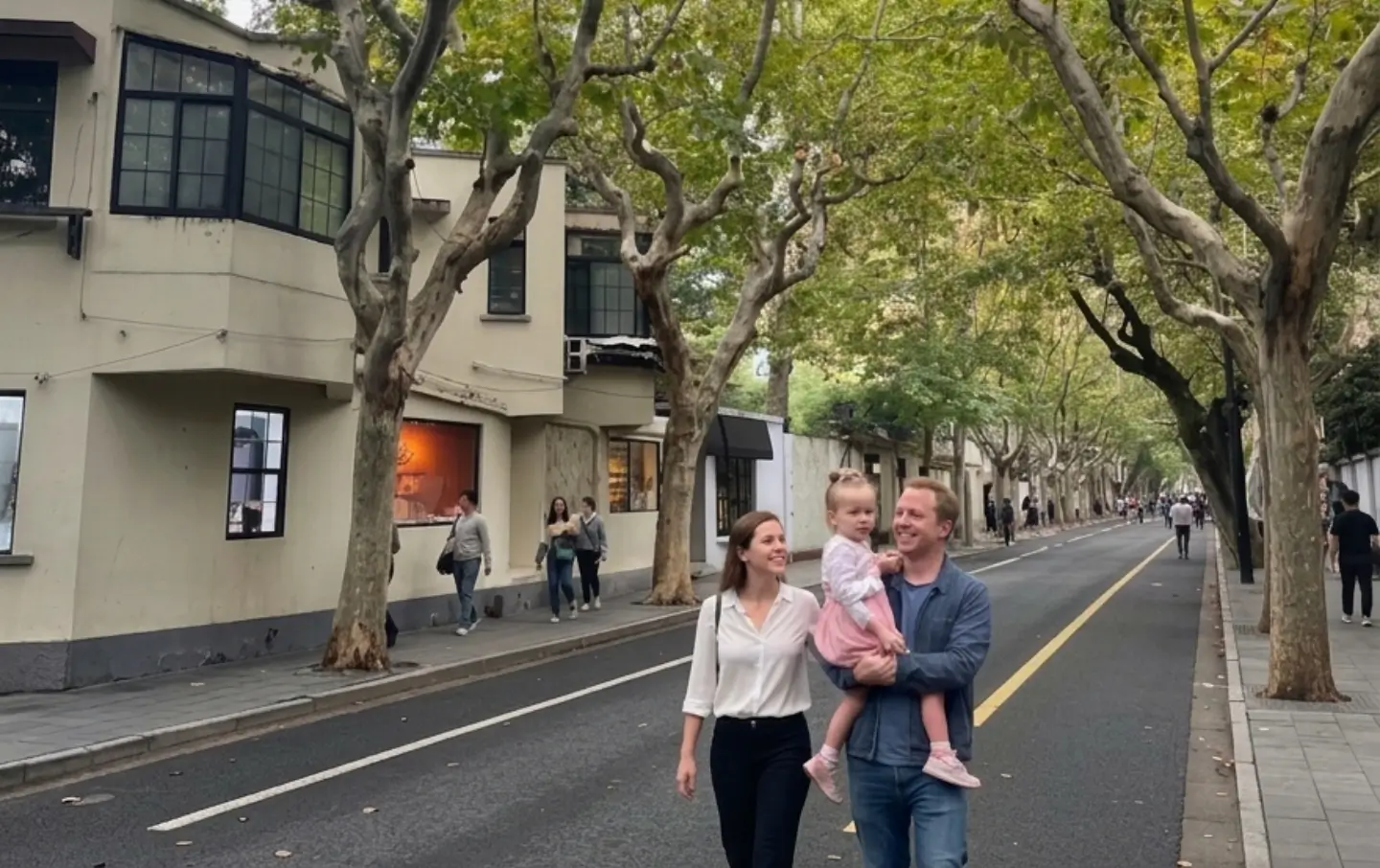 family walking on tree lined street in Shanghai French Concession city walk experience