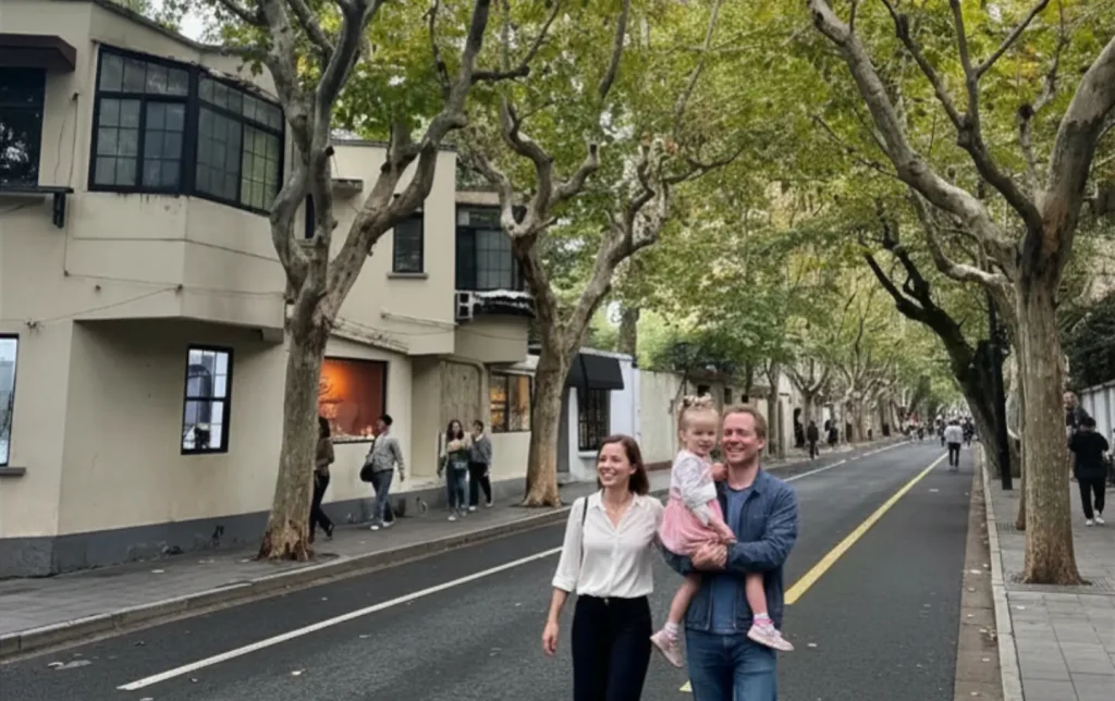 family walking along tree lined street in Shanghai French Concession city walk experience
