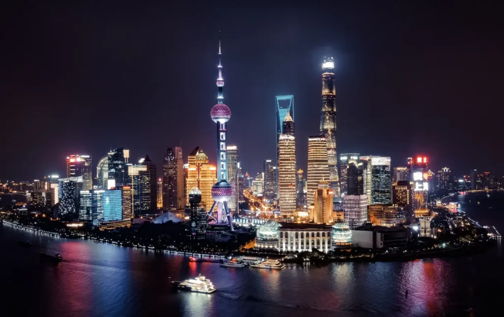 shanghai skyline at night with oriental pearl tower and pudong skyscrapers along huangpu river