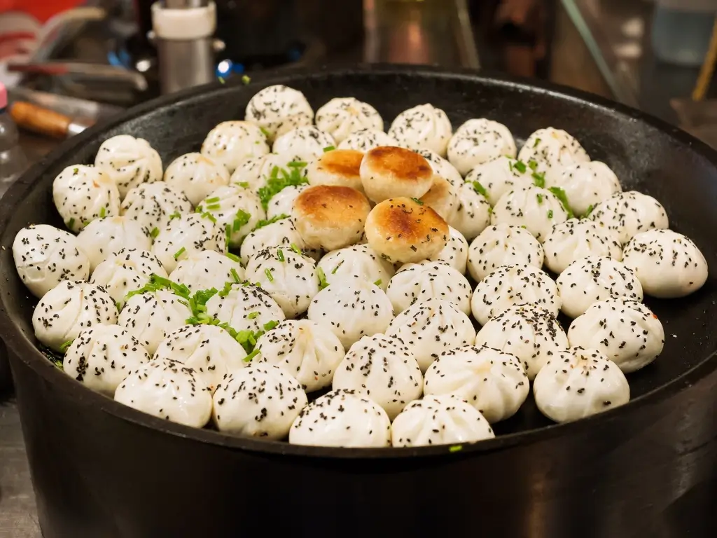 Shengjianbao pan-fried buns with sesame topping, popular Shanghai street food