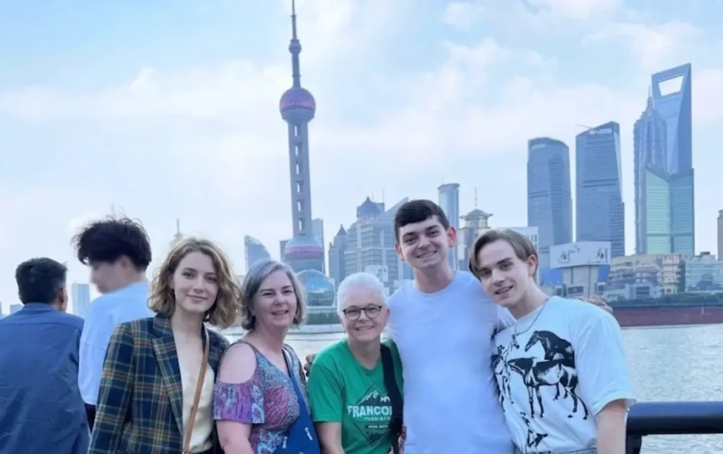 Tourists posing at the Bund with Shanghai skyline in the background