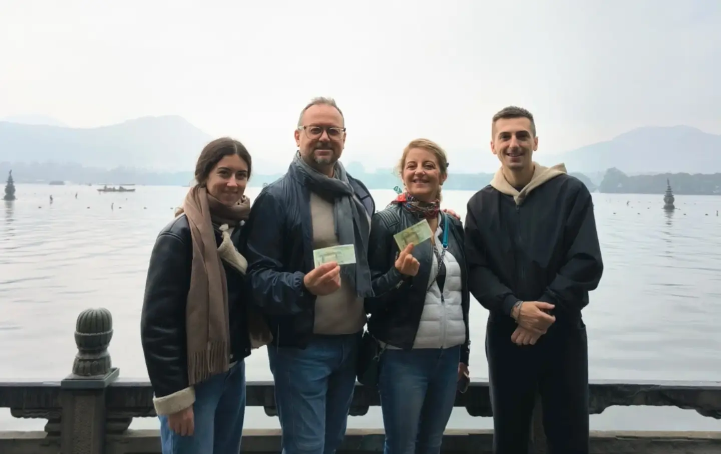 group of Western tourists enjoying West Lake Hangzhou scenic view during travel experience