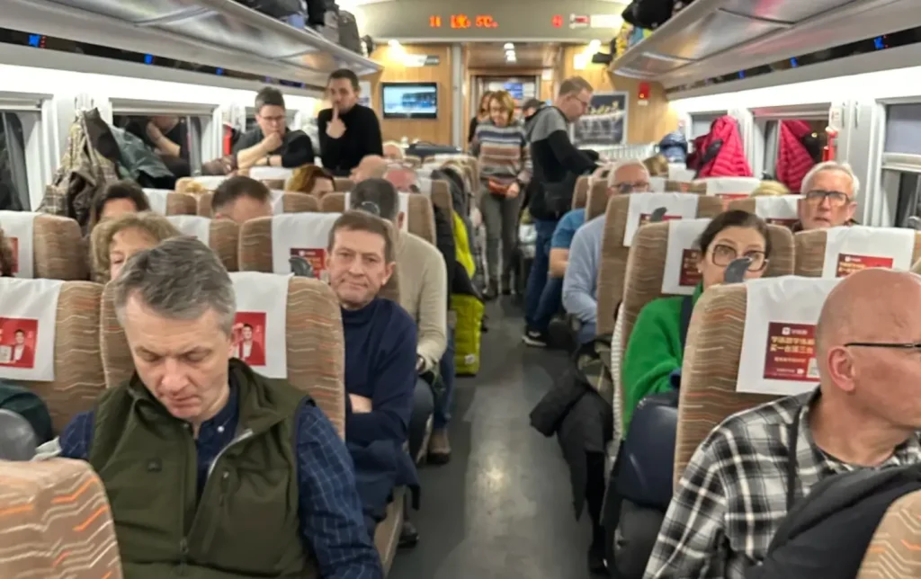 interior of China high speed train from Shanghai to Hangzhou with passengers and luggage racks