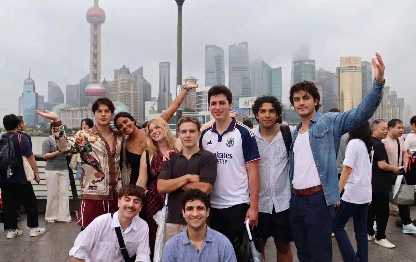 group of young travelers enjoying the Shanghai Bund skyline during a China travel experience