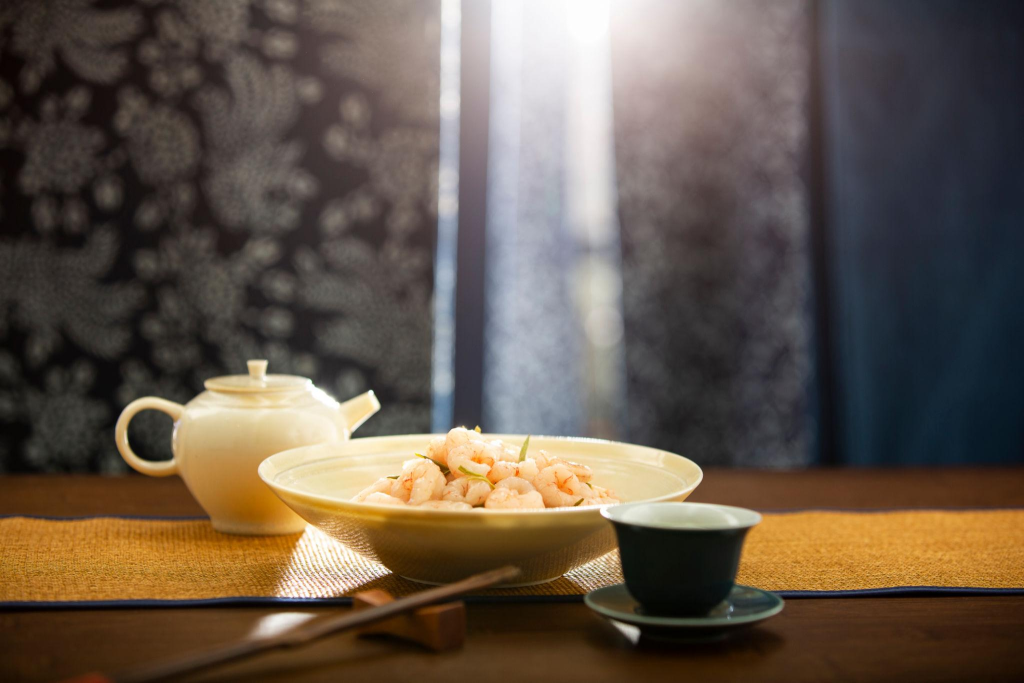 Famous Hangzhou dish Longjing shrimp served with Longjing tea