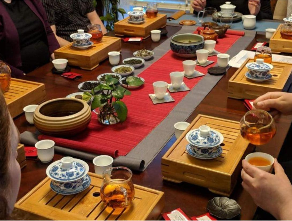 Guests enjoying a traditional Longjing tea tasting experience in Hangzhou