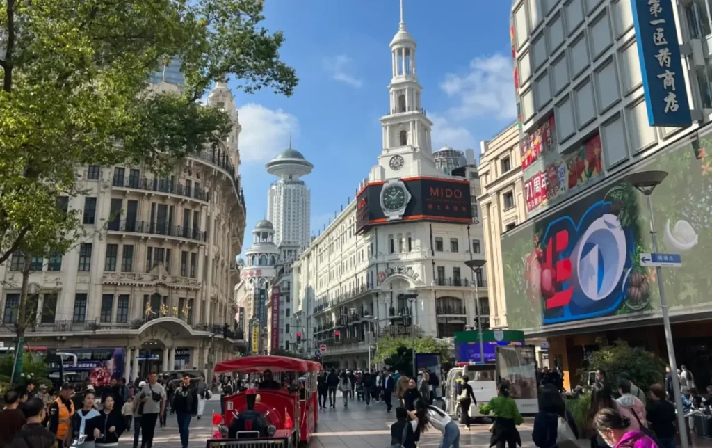 Nanjing Road pedestrian street in Shanghai during daytime with shoppers and city atmosphere