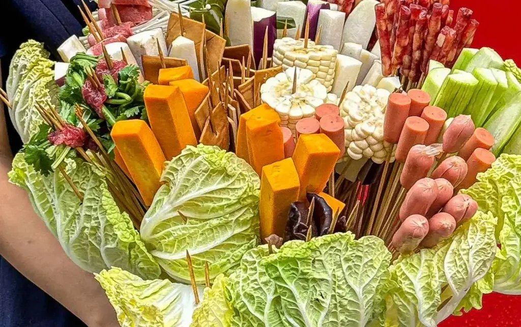 Chengdu chuanchuanxiang skewer bouquet displayed in red bucket with vegetables and meat on bamboo sticks