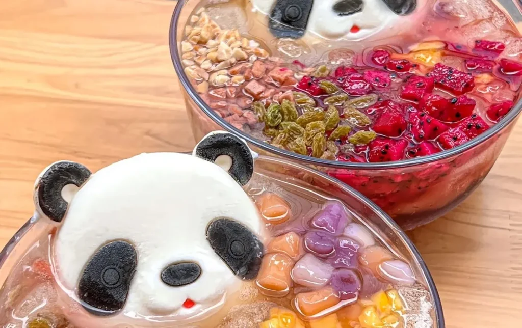 Chengdu panda-shaped bingfen ice jelly dessert with colorful fruit toppings in glass bowls