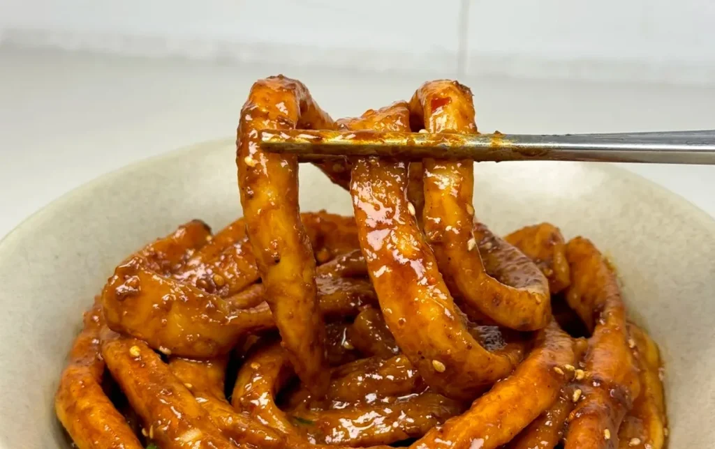 Chengdu tianshui mian sweet water noodles thick chewy noodles with spicy sesame sauce in white bowl