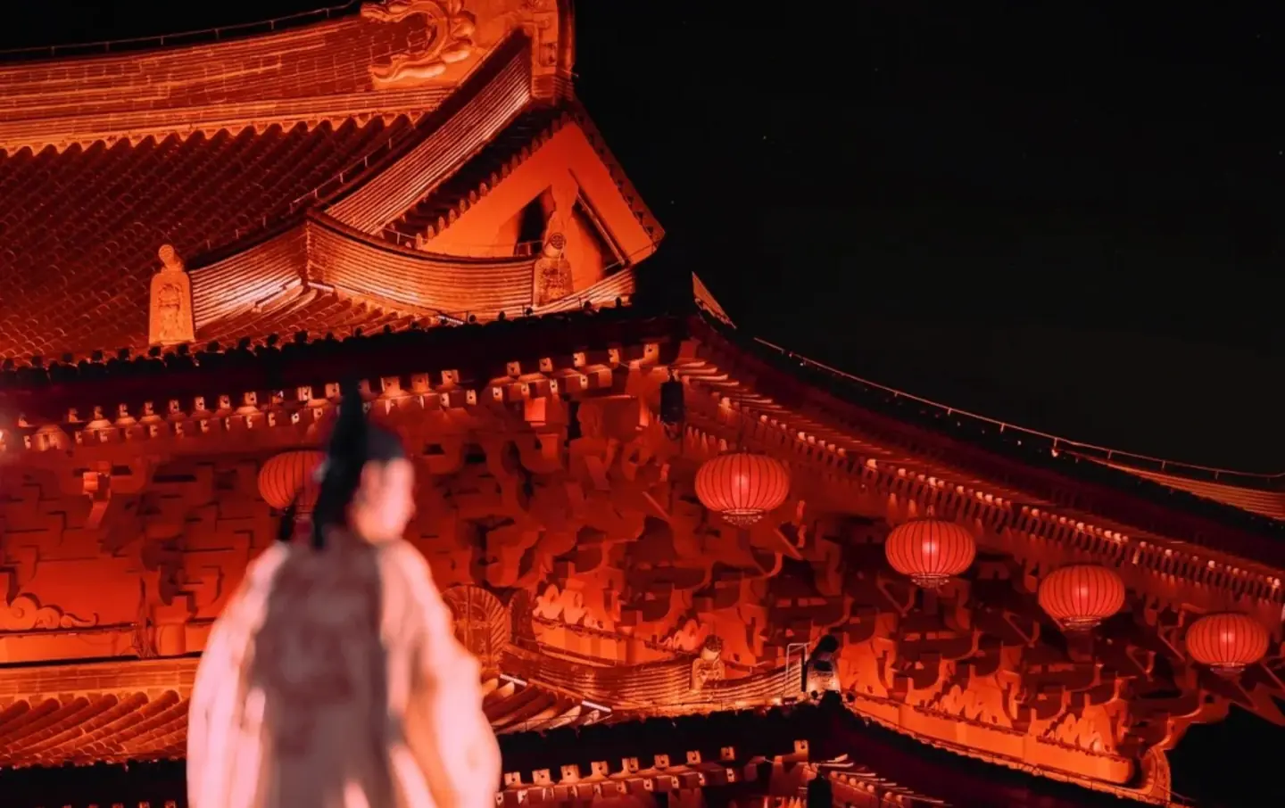 Hanfu-dressed visitor admiring lantern-lit pagoda building at Grand Tang Mall, Grand Tang Mall night tours