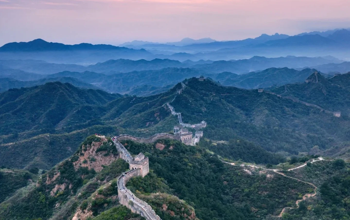 Breathtaking aerial view of Jinshanling Great Wall snaking across layered mountain ridges at sunset — Beijing Great Wall photography tour