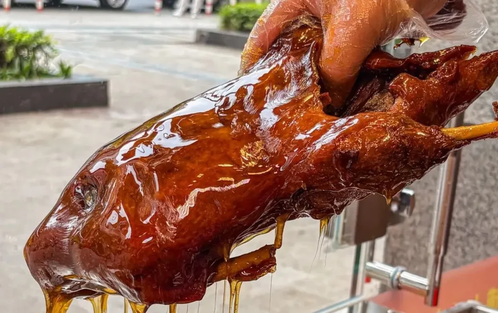 Leshan tianpiya sweet skin roast duck with glossy caramel glaze dripping traditional Sichuan specialty