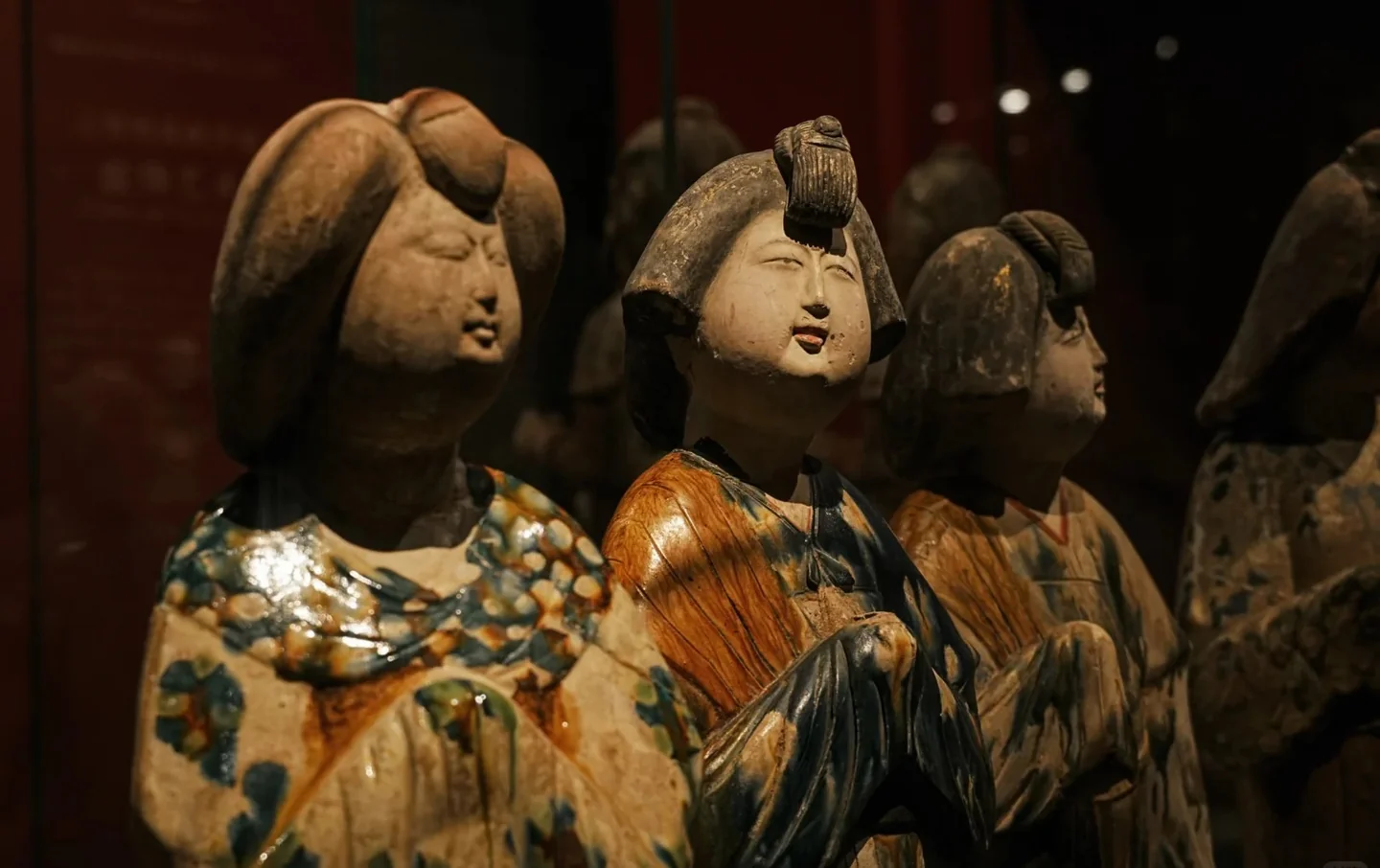 Close-up of Tang dynasty sancai three-color glazed ceramic court ladies with elaborate hairstyles and robes displayed in Shaanxi History Museum, Xi'an