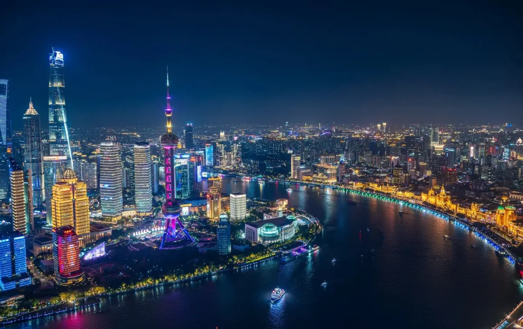 Full-night aerial view of Shanghai Lujiazui with neon-lit skyscrapers and the Bund reflected in the Huangpu River — Shanghai night tour