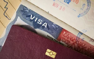 Close-up of a United States of America visa sticker and entry stamps inside a passport for international travel