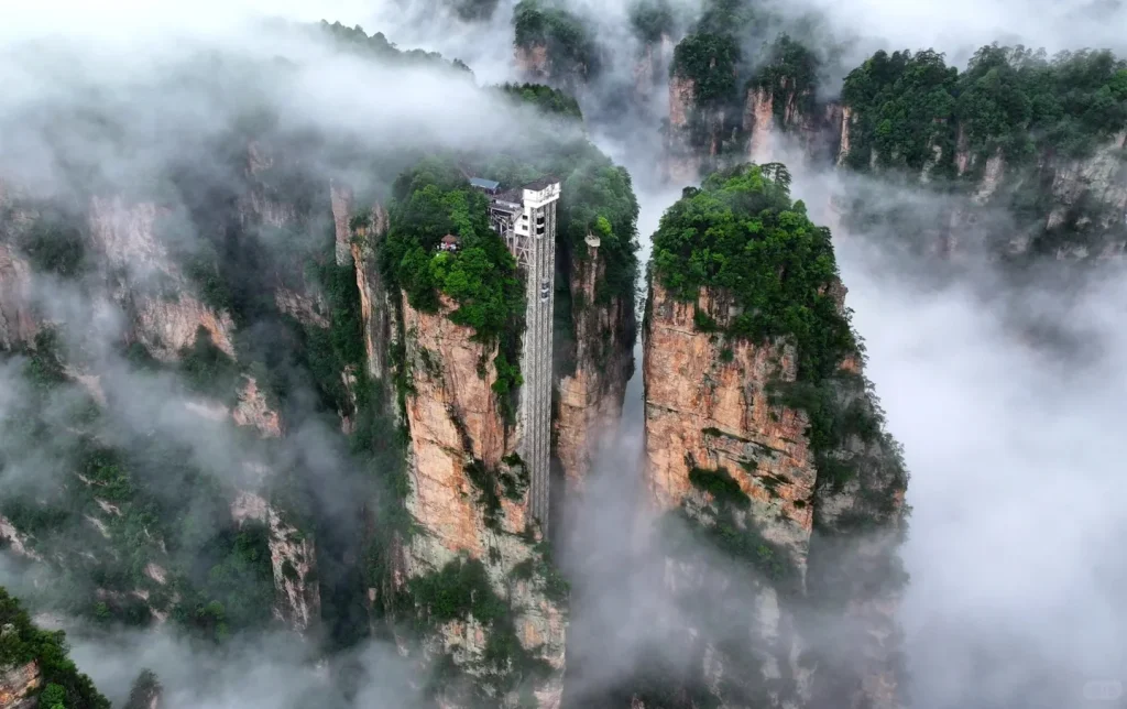 Zhangjiajie Bailong Elevator rising through misty peaks, a highlight on private Zhangjiajie tours