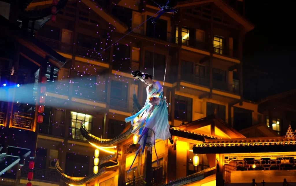 Aerial acrobatic show at Dayong Ancient City's Qilou Stage, a Zhangjiajie night tour highlight