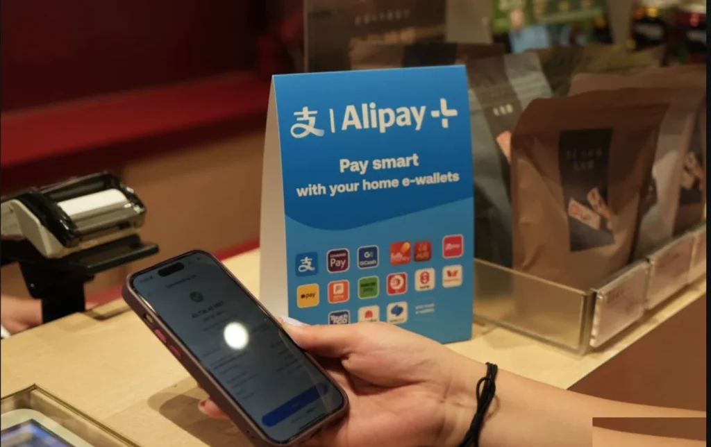 Alipay+ payment sign at a retail counter showing supported international e-wallets for foreign tourists visiting China, making cashless travel in China easy